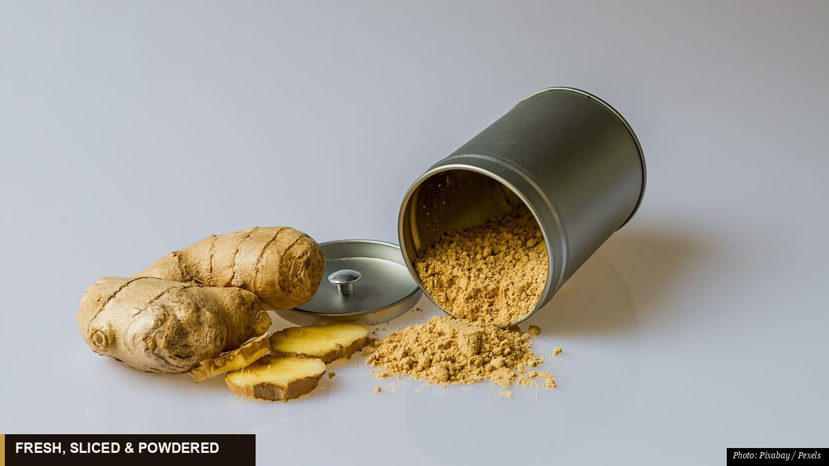 Fresh ginger root with sliced pieces and ground ginger powder spilling from a tin