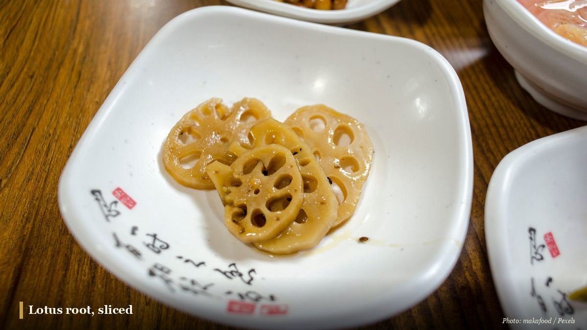 Braised sliced lotus root on a dish showing its characteristic holes
