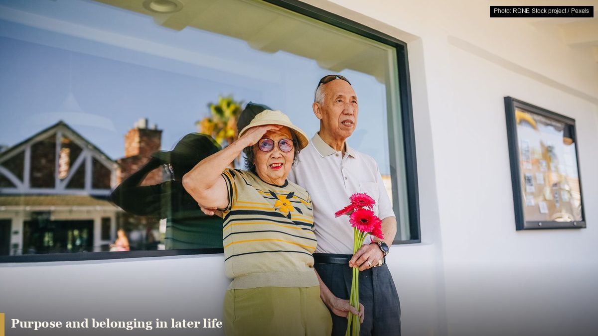 Elderly Asian couple smiling together outdoors, illustrating social connection in later life