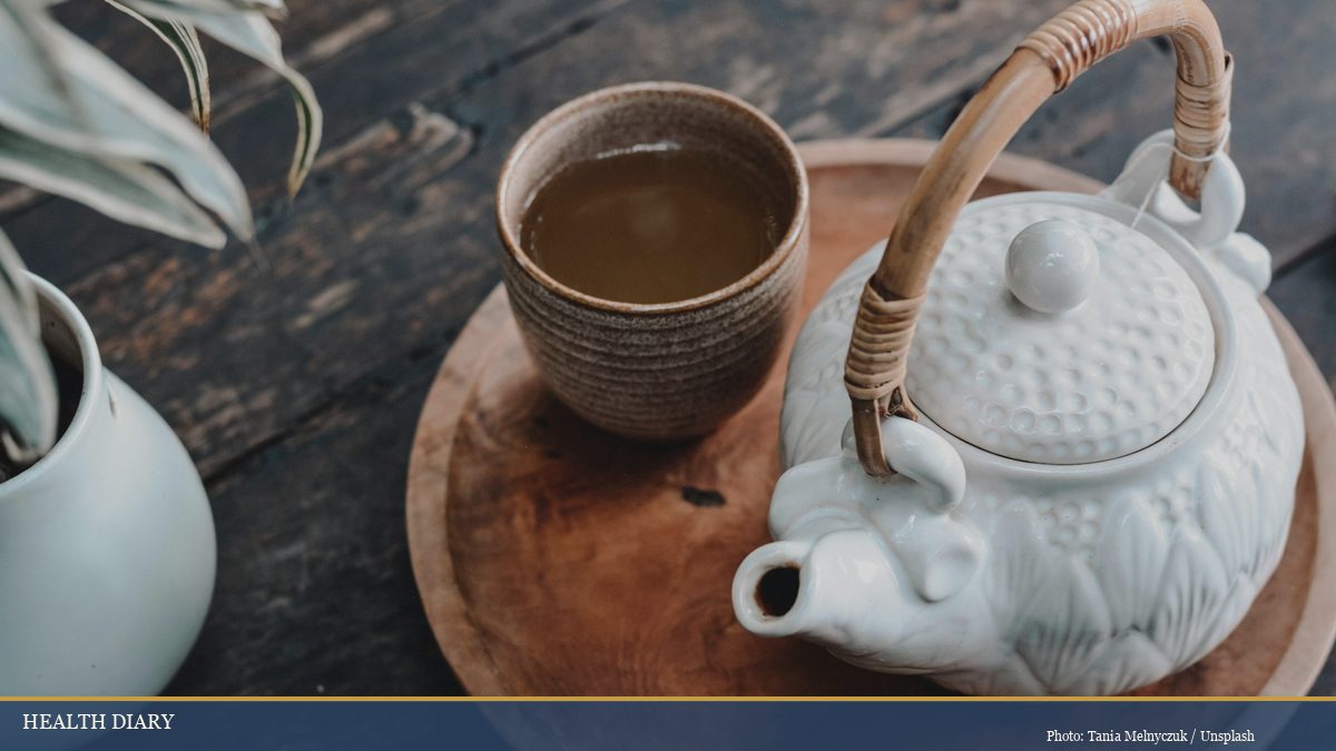 Ceramic Japanese teapot and tea bowl on wooden tray evoking chashitsu wabi-sabi aesthetic