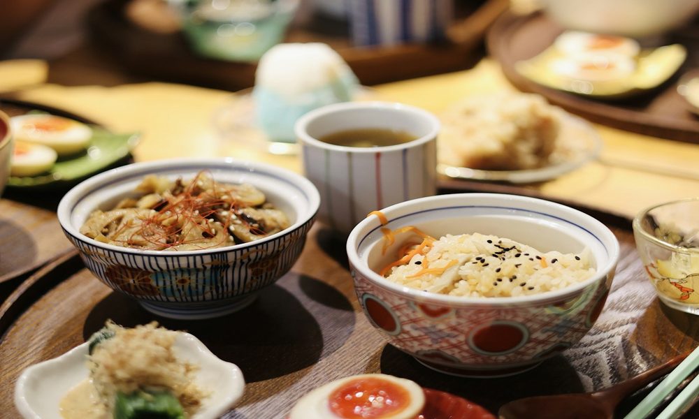 Traditional Japanese multi-dish meal spread illustrating yakuzen seasonal food therapy and Japanese wellness cooking