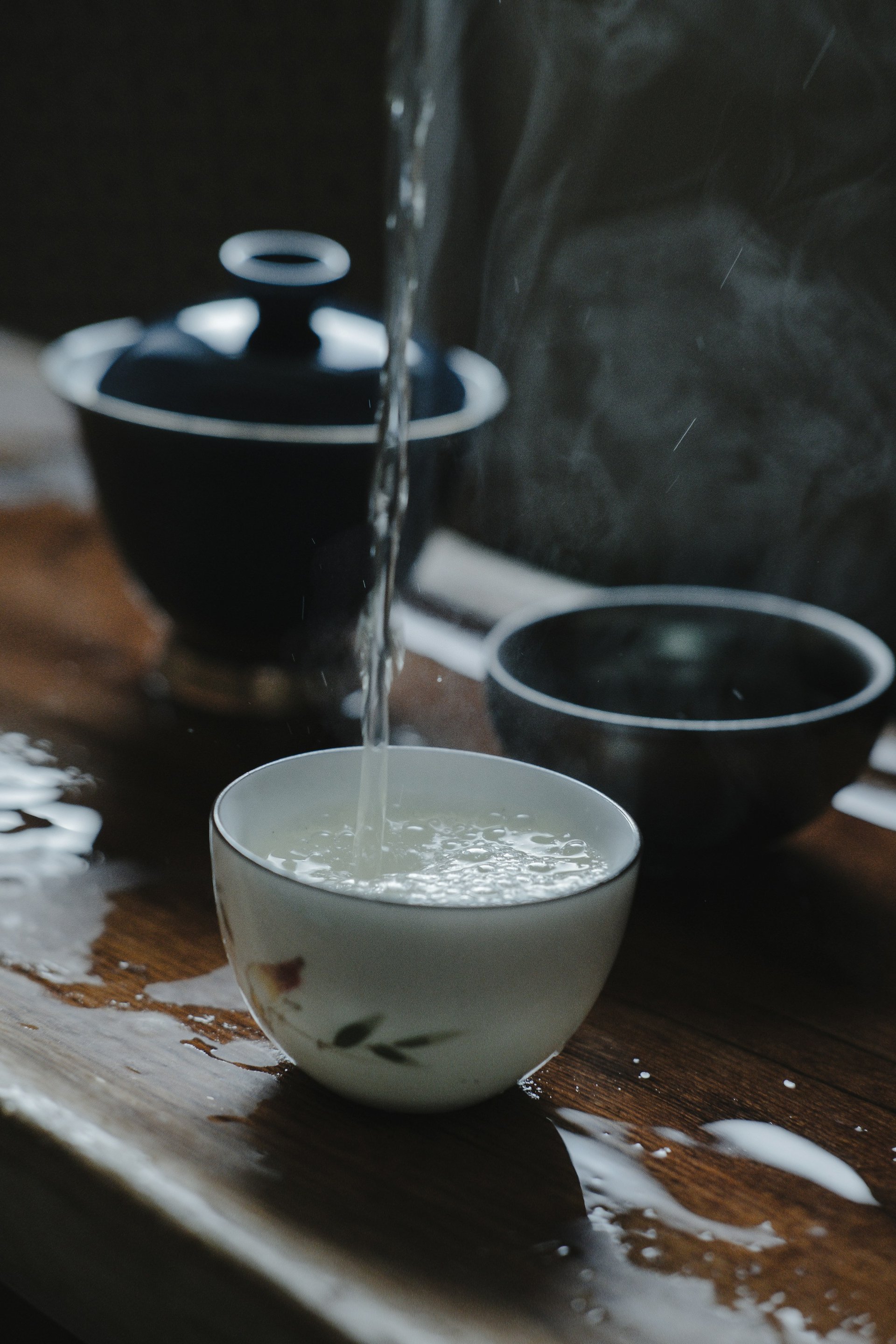 A pale golden cup of brewed kukicha twig tea in a simple Japanese ceramic cup, showing the characteristic very light colour