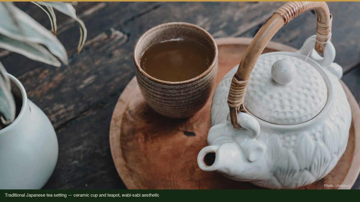 Traditional Japanese tea setting with ceramic cup and teapot on wooden tray, wabi-sabi aesthetic