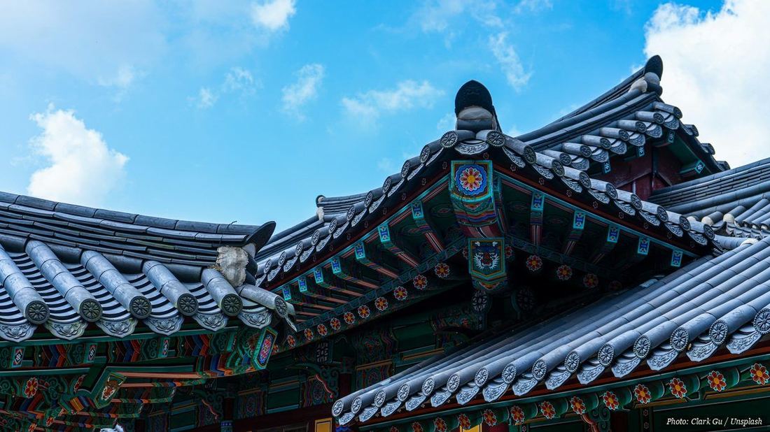Colorful painted eaves and tiled roofs of a Korean Buddhist temple