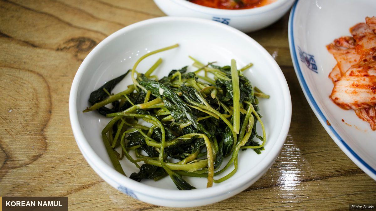 Assorted Korean spring namul greens dressed with sesame in a bowl