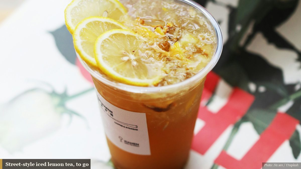 Takeaway cup of iced tea with lemon slices from a street tea stand