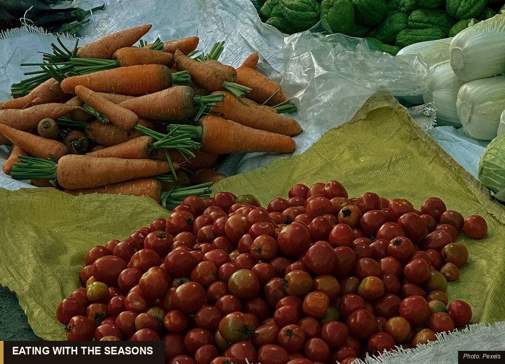 Fresh seasonal Asian vegetables displayed at an open-air produce market