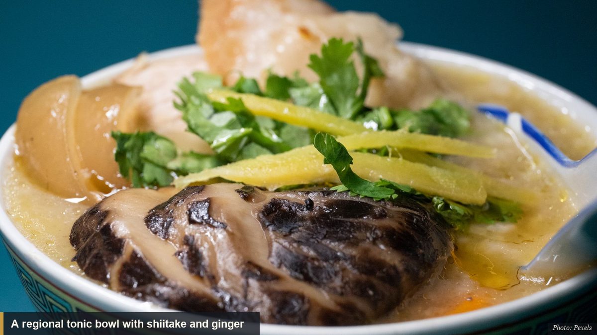 Traditional Asian soup with shiitake mushroom and ginger in a decorated bowl