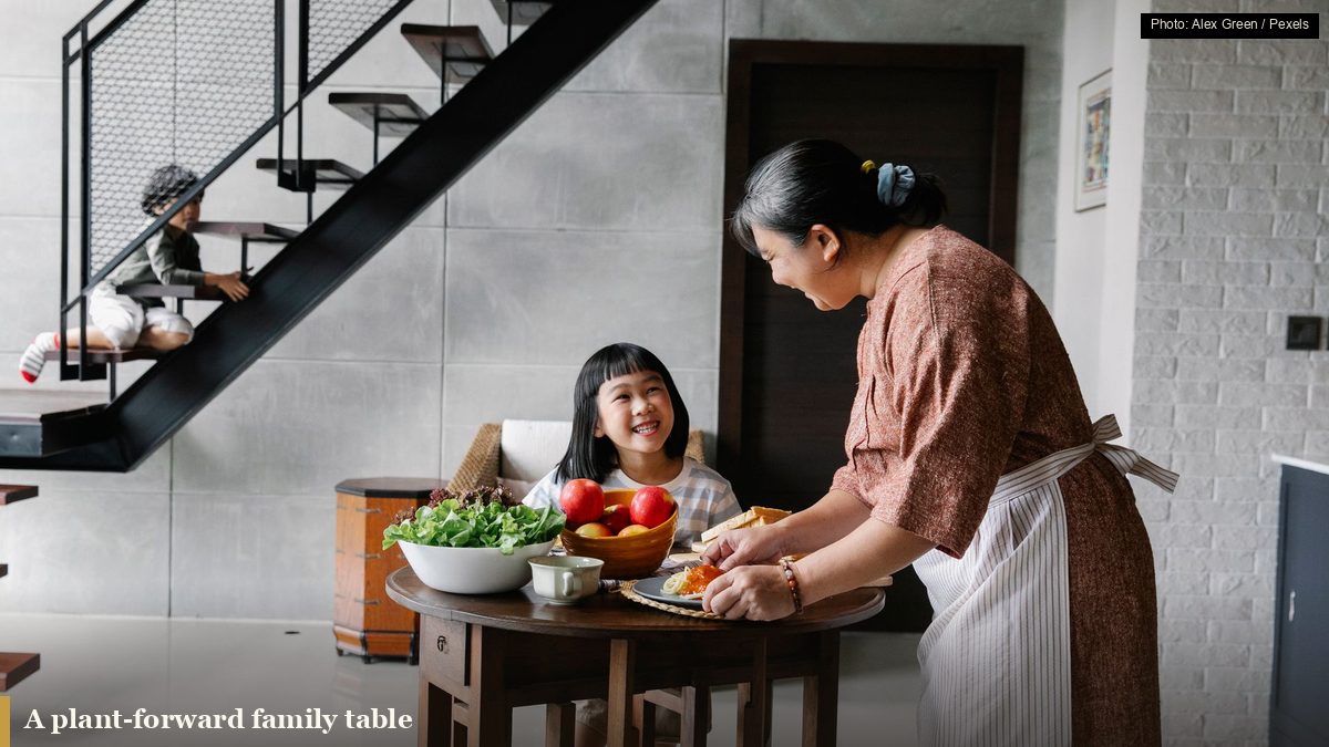 A grandmother sharing a plant-forward home-cooked meal with her grandchild