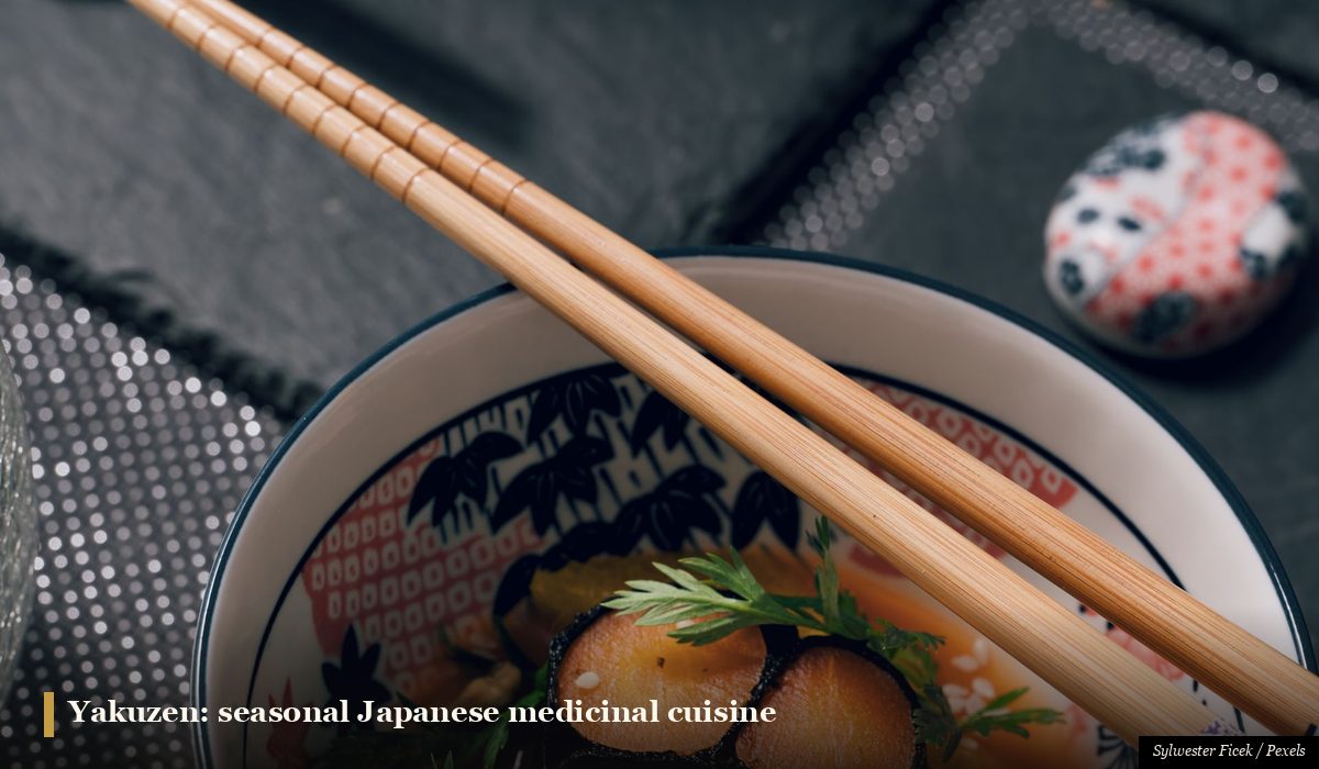 Seasonal Japanese medicinal cuisine yakuzen bowl with fresh herbs vegetables and broth