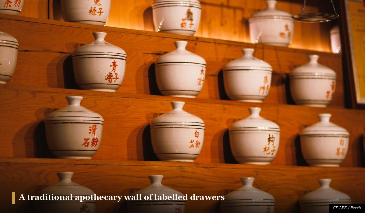 Japanese kampo pharmacy wall of small labelled drawers holding dried herbal medicines