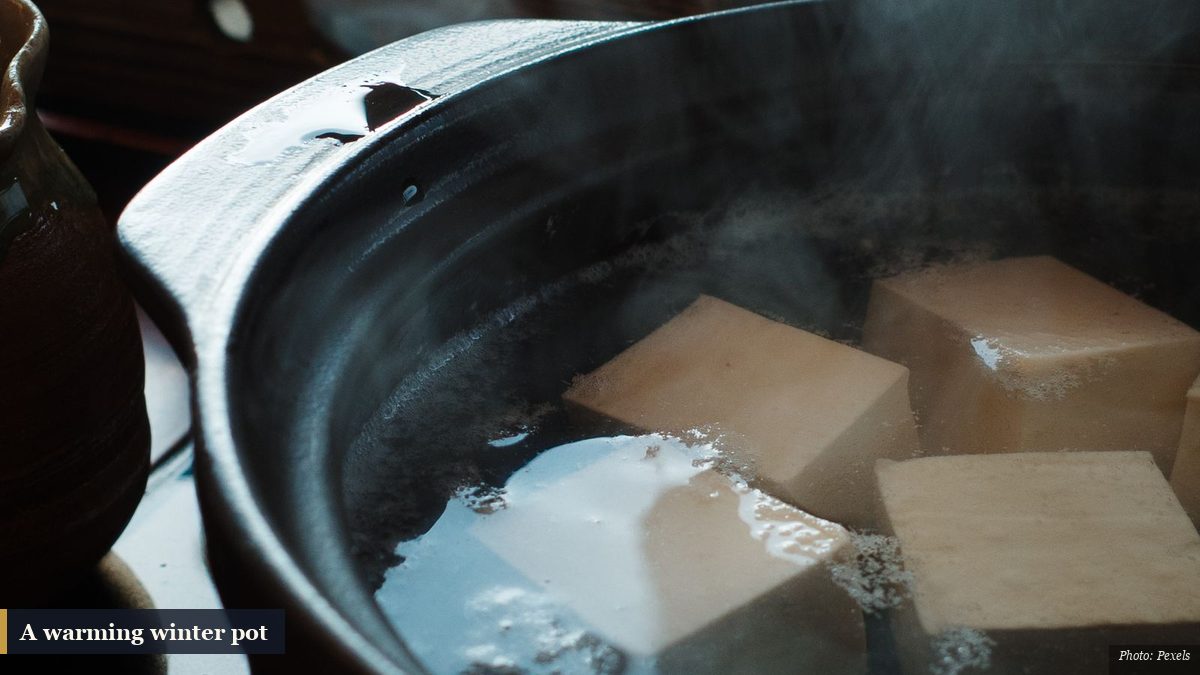 Steaming simmered tofu hot pot in a dark clay pot, a warming winter dish