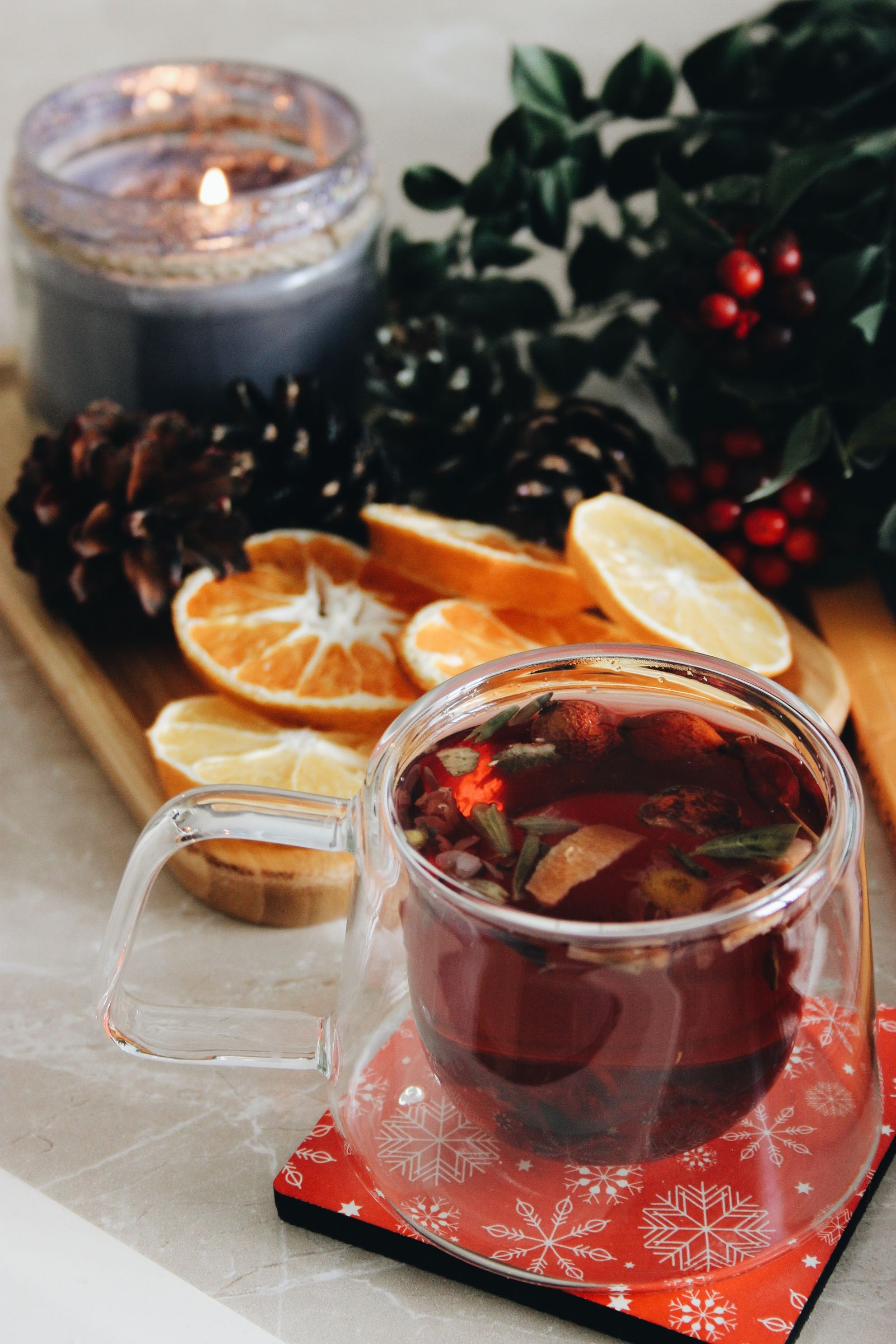 A warm cup of yuja-cha Korean citron tea with citrus slices and winter decorations